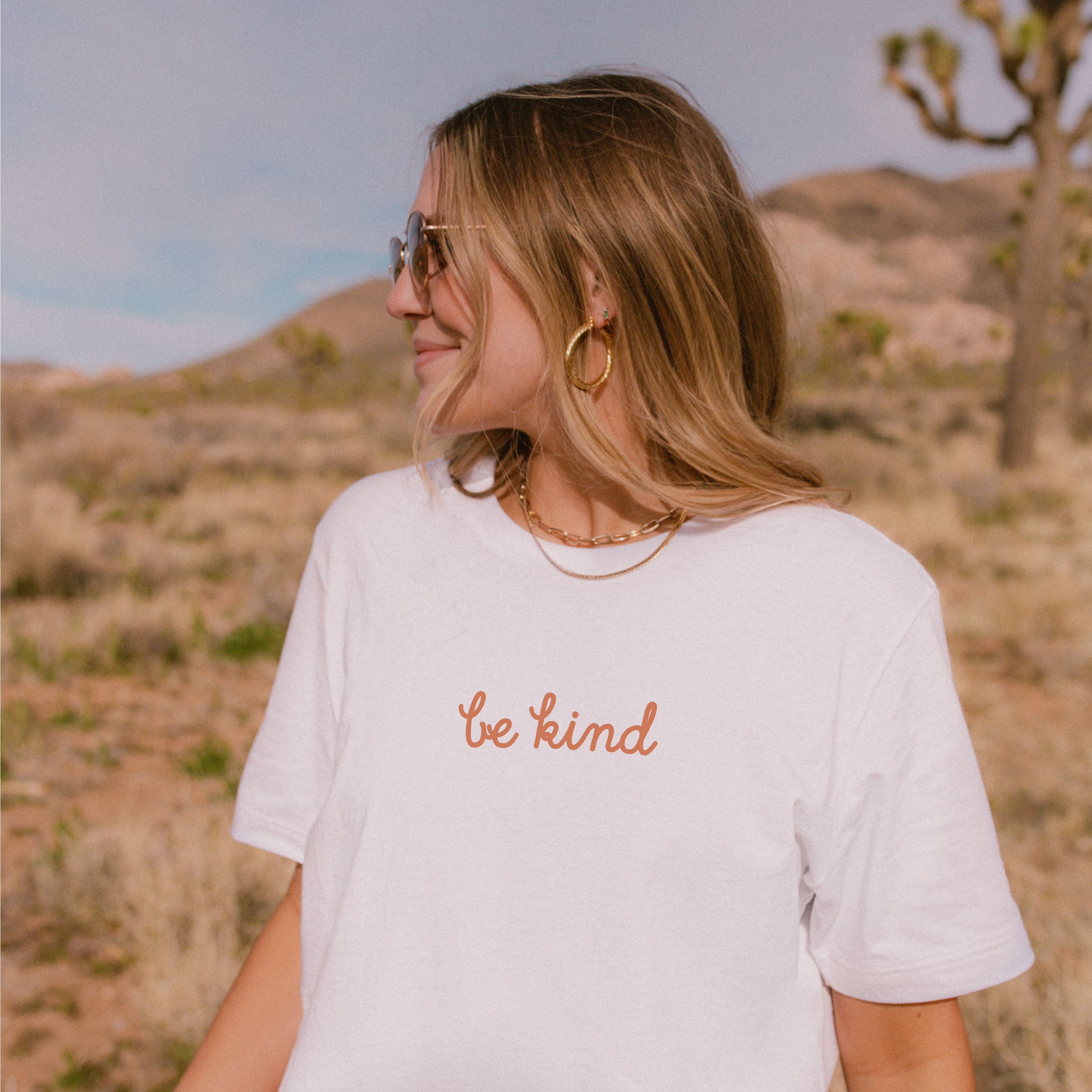 Natural tee with small “be kind” text on front chest and bold “love yourself” text across back