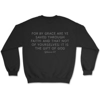 Light-colored sweatshirt with “Saved by Grace” text on front and full Ephesians 2:8 verse on back